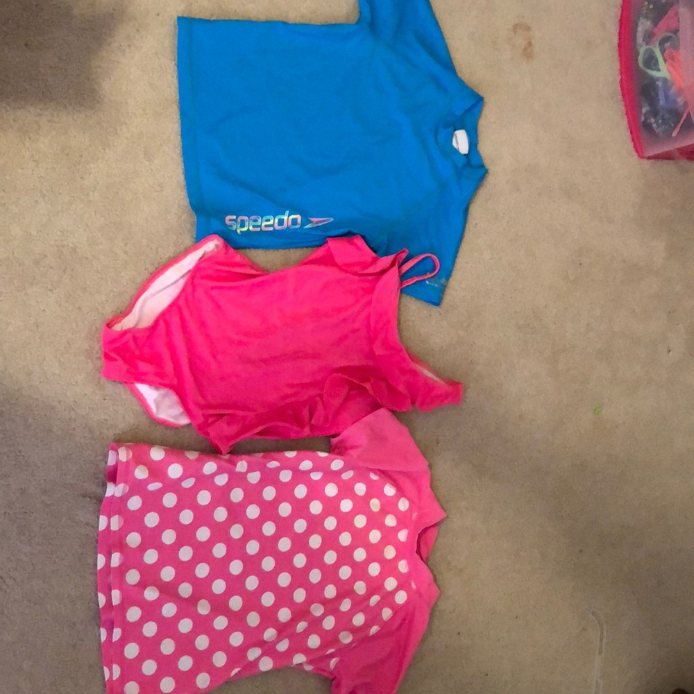 2 girls rash guards and 1 one-piece swim suit